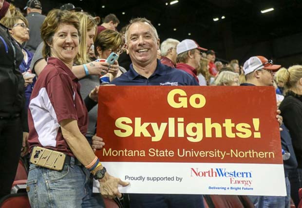 Tammy & David Boles holding "Go Skylights" sign
