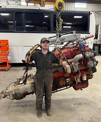 Rory Cozzens in front of a large engine